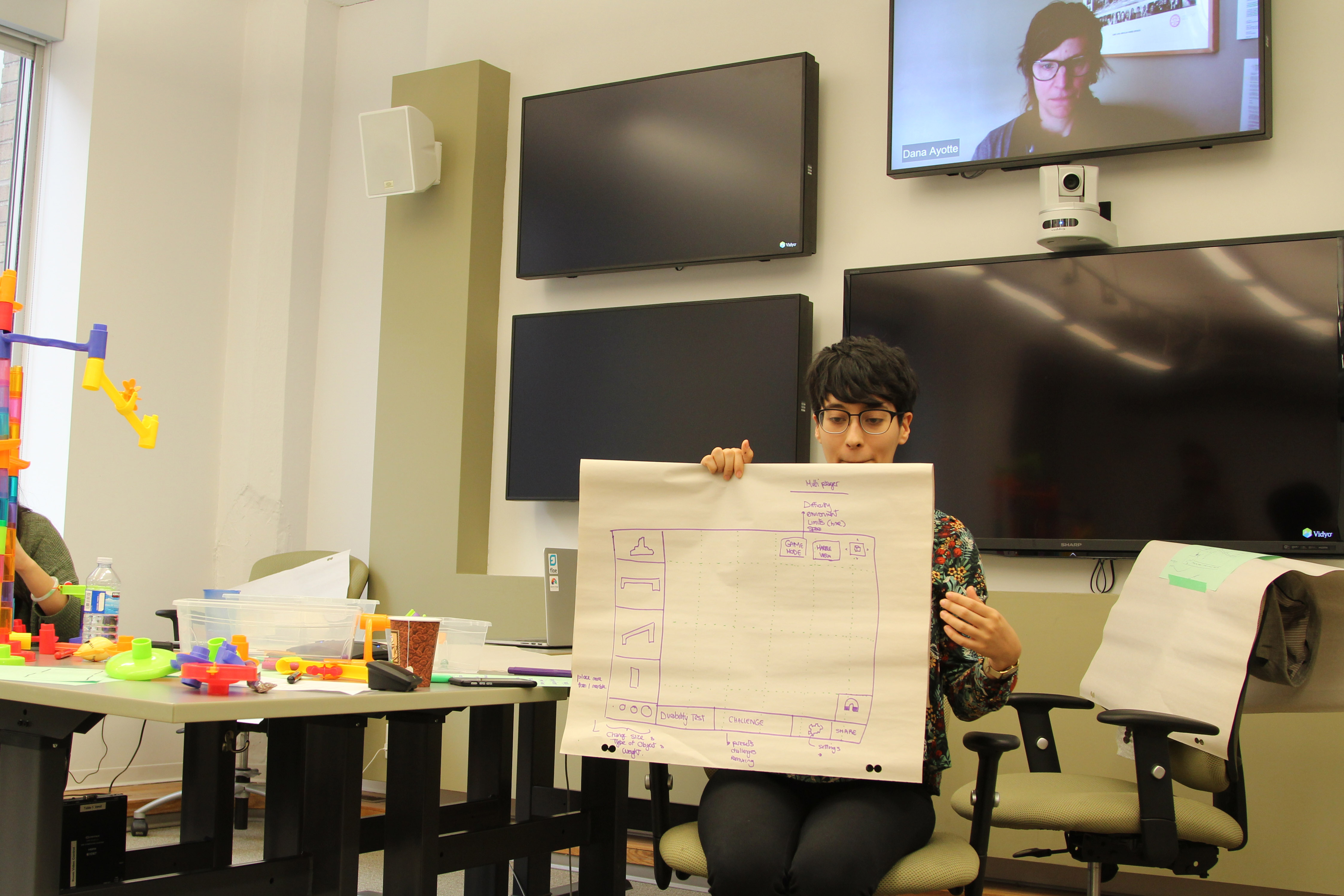 An image of a Create-a-Thon participant describing their group's
design.